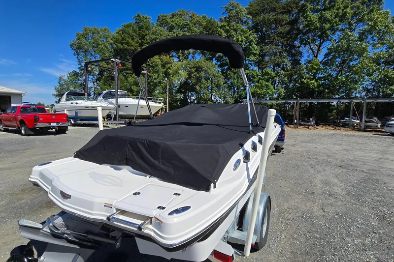 Slide: The Image of 2012 Chaparral 196 SSi boat on trailer, covered, in outdoor storage area. - 2