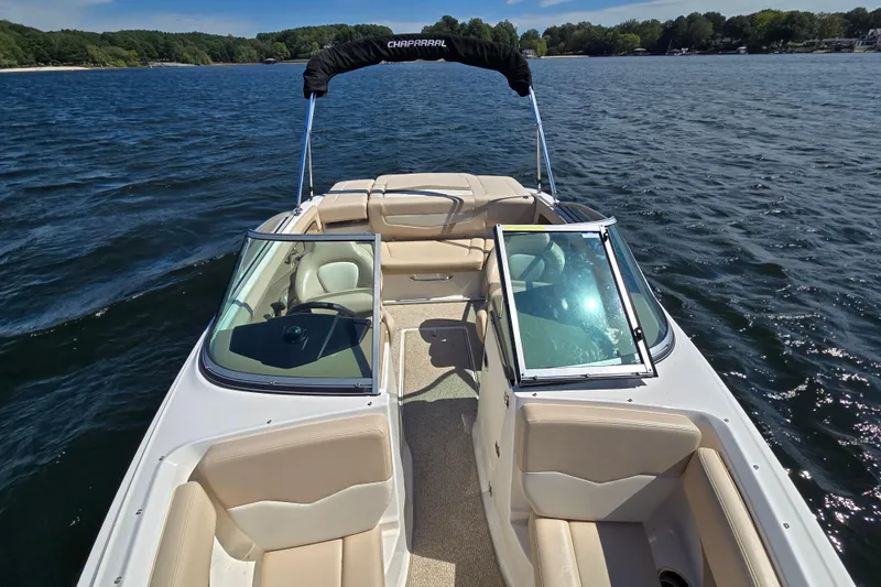 Slide: The Image of 2012 Chaparral 196 SSi boat on a lake, featuring open seating and clear skies. - 21