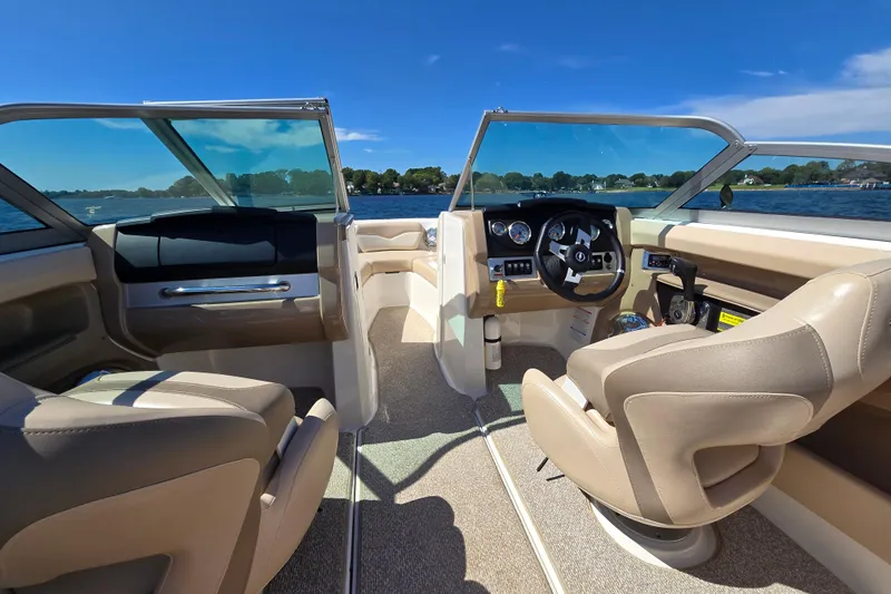 Slide: The Image of Interior view of 2012 Chaparral 196 SSi boat with beige seating and dashboard controls. - 25