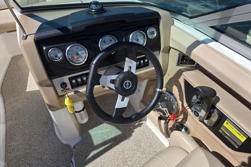 Slide: The Image of 2012 Chaparral 196 SSi boat dashboard with steering wheel and gauges. - 26