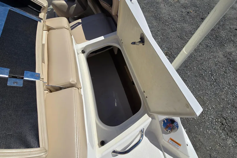 Slide: The Image of Open storage compartment on 2012 Chaparral 196 SSi boat with beige seating. - 30