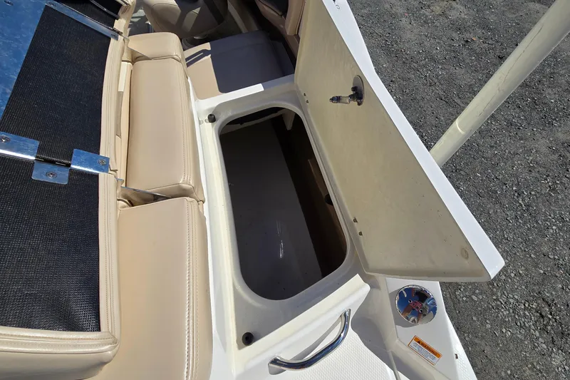 Slide: The Image of Open storage compartment on 2012 Chaparral 196 SSi boat with beige seating. - 31