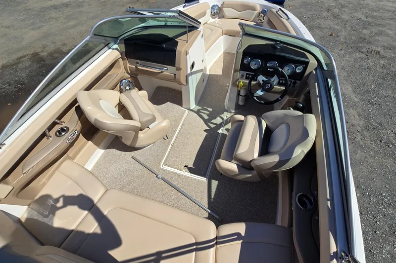 Slide: The Image of Interior view of 2012 Chaparral 196 SSi boat with beige seating and dashboard. - 32
