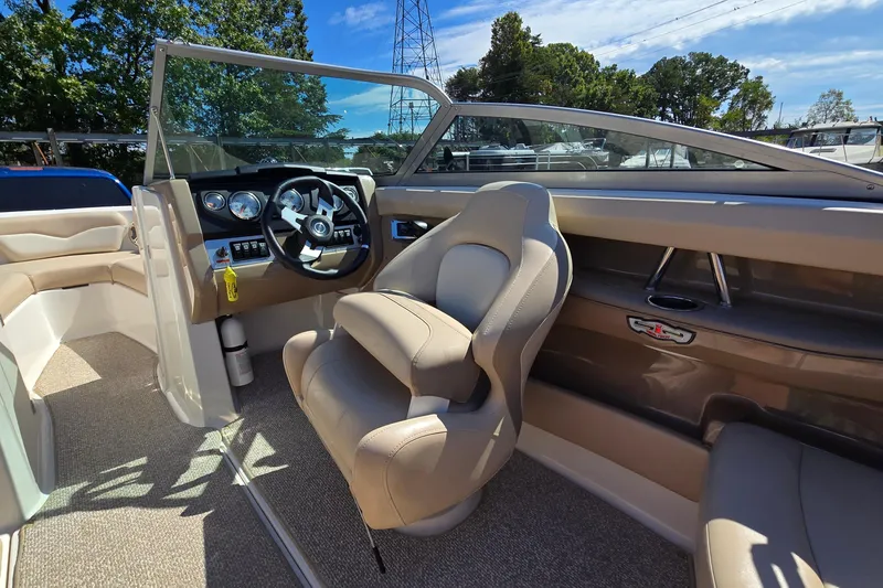 Slide: The Image of Interior of a 2012 Chaparral 196 SSi boat with steering wheel and seating. - 36