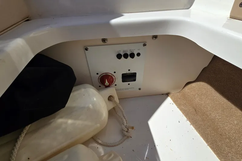 Slide: The Image of 2012 Chaparral 196 SSi boat interior control panel with switches and ropes. - 37