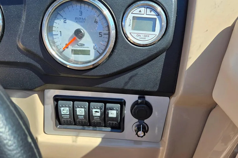 Slide: The Image of Dashboard controls of a 2012 Chaparral 196 SSi boat, featuring RPM gauge and switches. - 39