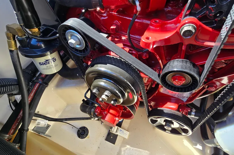 Slide: The Image of Engine components of a 2012 Chaparral 196 SSi boat, featuring belts and pulleys. - 48