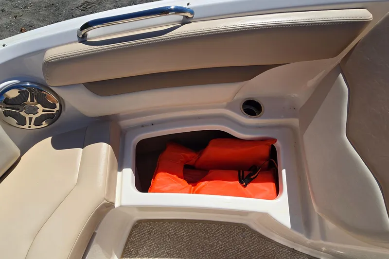 Slide: The Image of 2012 Chaparral 196 SSi boat interior with storage compartment and life jackets. - 52
