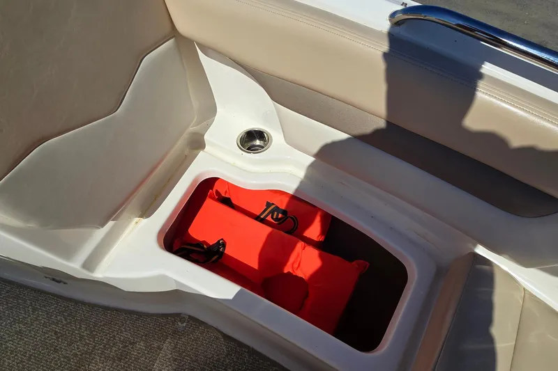 Slide: The Image of Storage compartment in 2012 Chaparral 196 SSi boat with life jackets. - 53