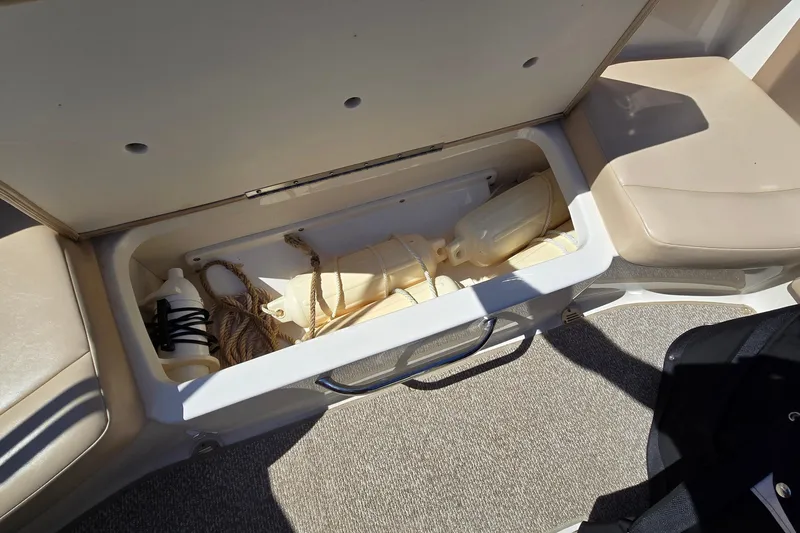 Slide: The Image of Storage compartment in 2012 Chaparral 196 SSi boat with ropes and fenders. - 54
