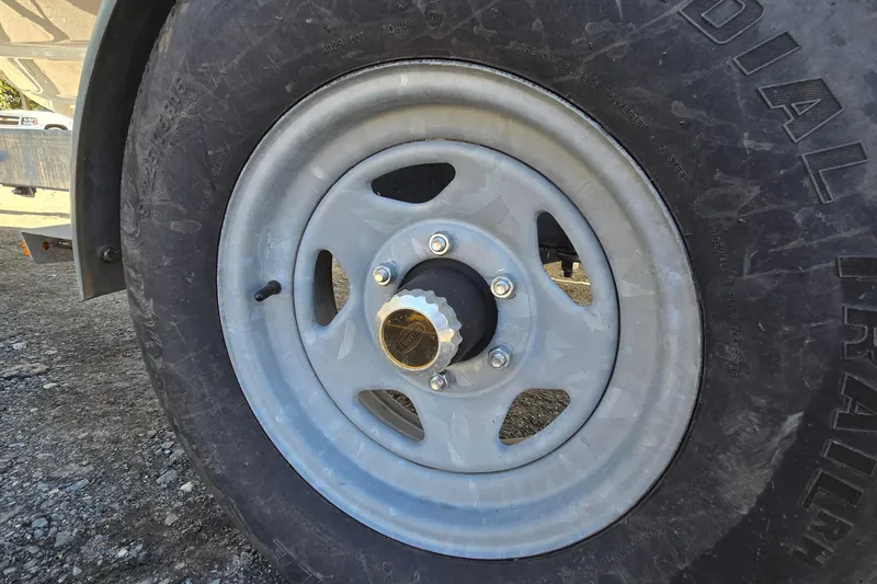 Slide: The Image of Trailer wheel of a 2012 Chaparral 196 SSi on gravel surface. - 56