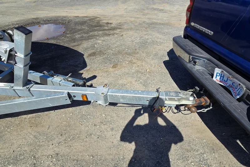 Slide: The Image of Trailer hitch connection to a blue Chevrolet Silverado, parked on gravel. - 59