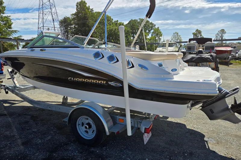 Slide: The Image of 2012 Chaparral 196 SSi boat on trailer, parked outdoors under clear sky. - 6