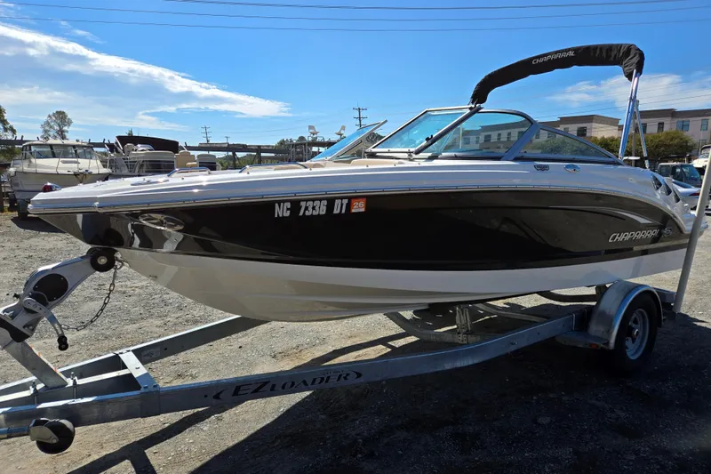 Slide: The Image of 2012 Chaparral 196 SSi boat on trailer, black and white design, sunny day. - 7