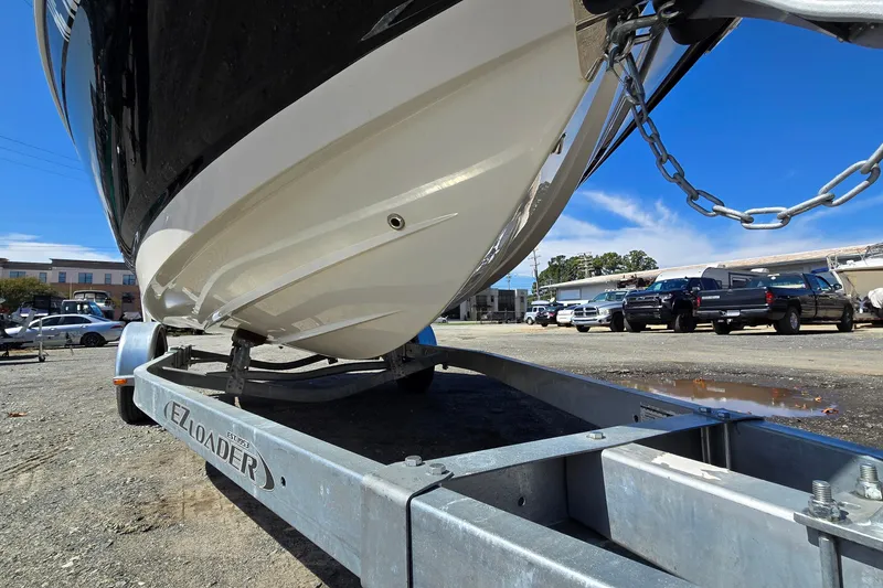 Slide: The Image of 2012 Chaparral 196 SSi boat on EZ Loader trailer in parking lot. - 8