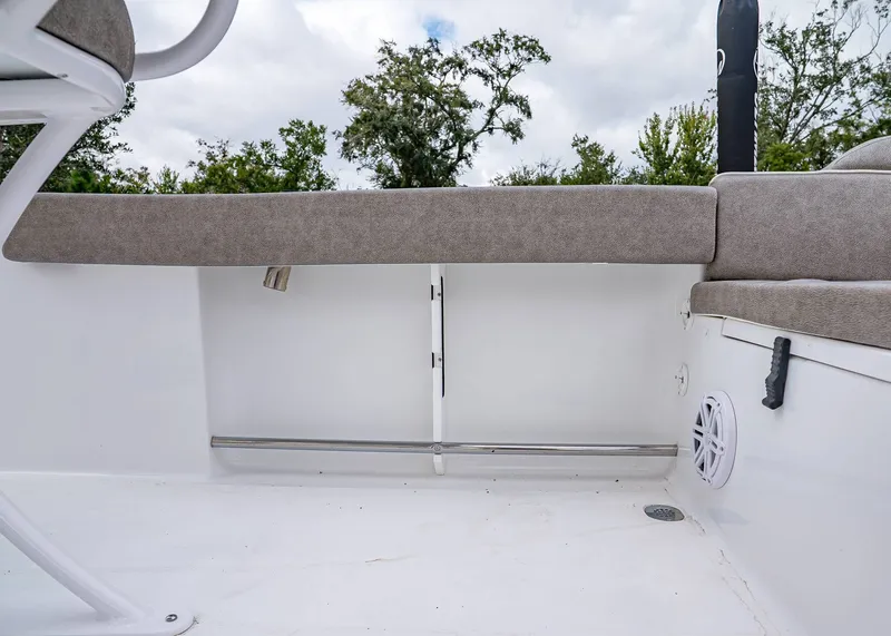 Slide: The Image of 2026 Sea Hunt Ultra 229 boat interior with cushioned seating and speaker. - 11