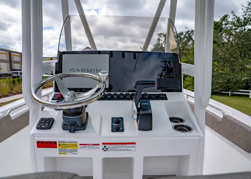 Slide: The Image of 2026 Sea Hunt Ultra 229 boat console with Garmin navigation, steering wheel, and controls. - 12