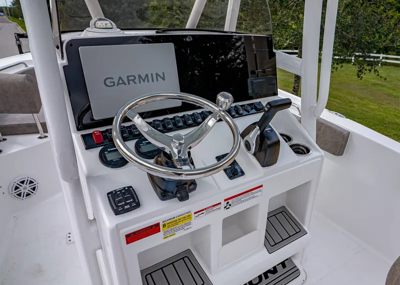 Slide: The Image of 2026 Sea Hunt Ultra 229 boat console with Garmin navigation system and steering wheel. - 13