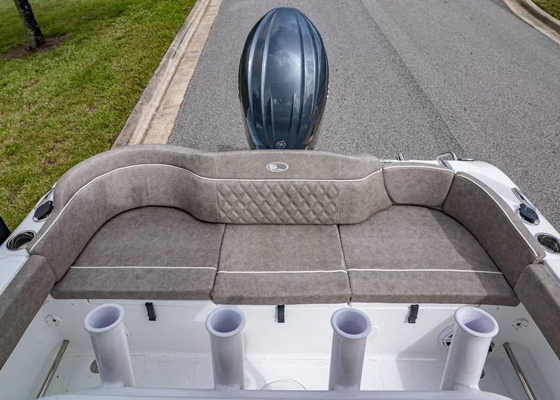 Slide: The Image of 2026 Sea Hunt Ultra 229 boat with cushioned seating and rod holders. - 4