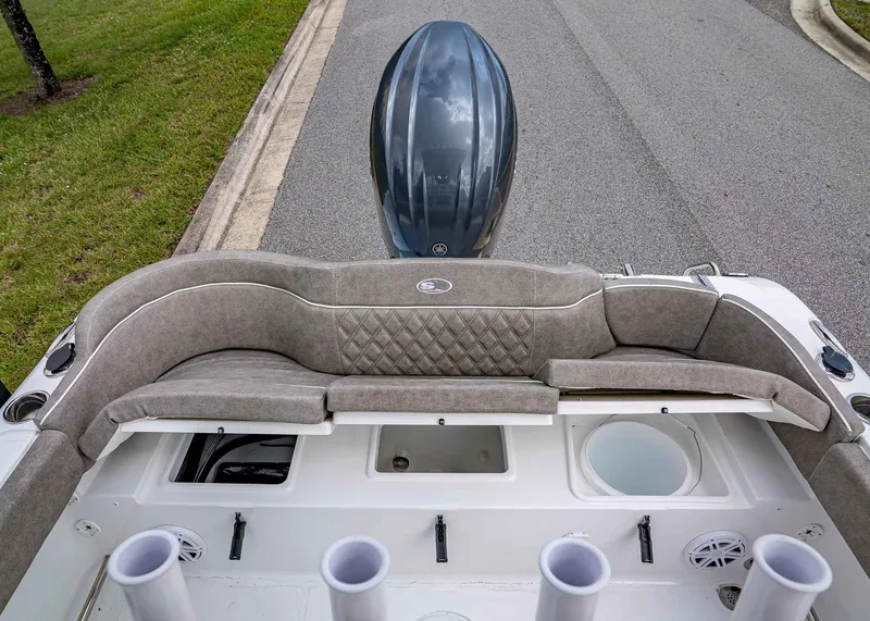 Slide: The Image of 2026 Sea Hunt Ultra 229 boat interior with cushioned seating and storage compartments. - 7