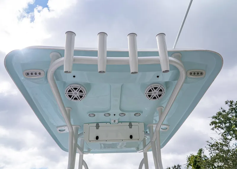 Slide: The Image of 2026 Sea Hunt Ultra 229 boat top view with rod holders and speakers against cloudy sky. - 9