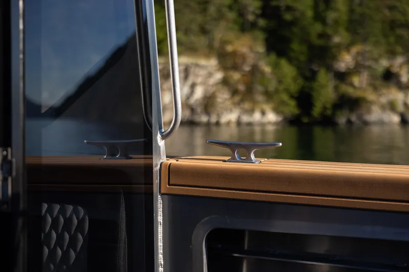 Slide: The Image of 2026 Jasper Marine Defender 22 boat detail with sleek design and scenic water backdrop. - 22