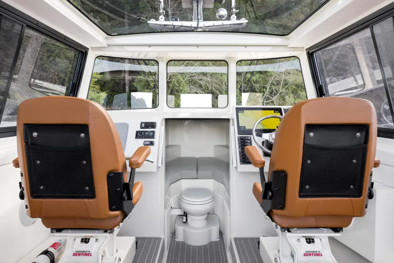 Slide: The Image of Interior of 2026 Jasper Marine Defender 22 boat with dual seats and navigation controls. - 24