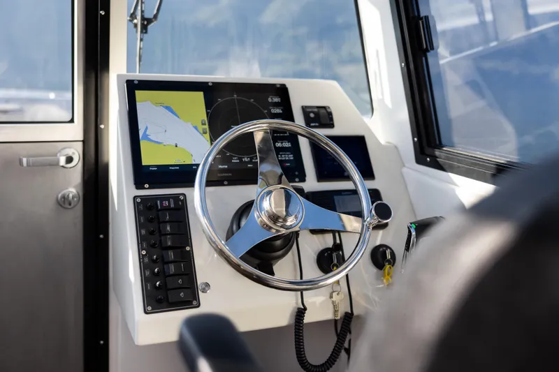 Slide: The Image of 2026 Jasper Marine Defender 22 boat cockpit with modern navigation system and steering wheel. - 27