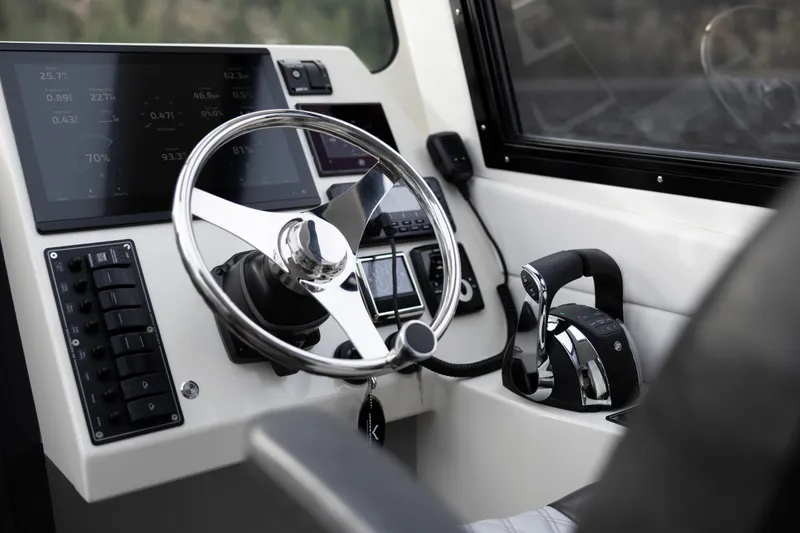 Slide: The Image of 2026 Jasper Marine Defender 22 cockpit with modern steering and control panels. - 33