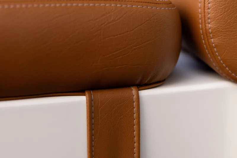 Slide: The Image of Close-up of brown leather upholstery on Jasper Marine Defender 22, 2026 model. - 43