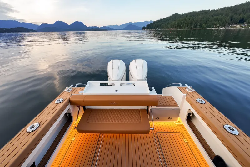 Slide: The Image of 2026 Jasper Marine Defender 22 boat on serene lake with scenic mountain backdrop. - 46
