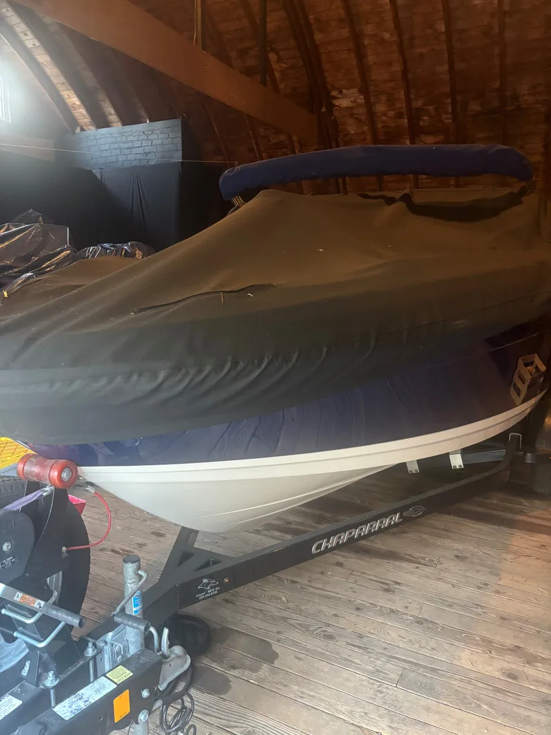 Slide: The Image of 2017 Chaparral Vortex 223 VR boat covered in storage facility. - 16