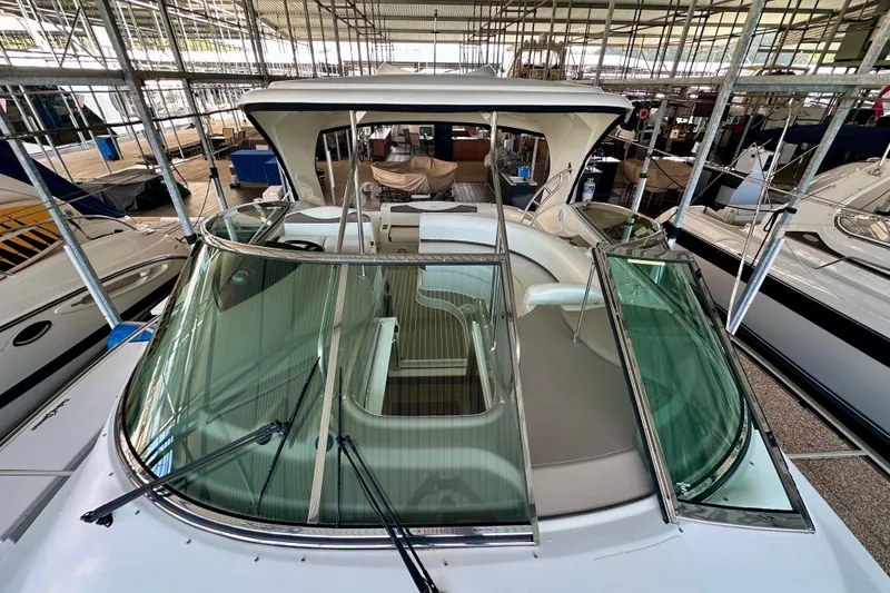 Slide: The Image of 2009 Cruisers Yachts 460 Express in marina, showcasing sleek design and spacious deck. - 13