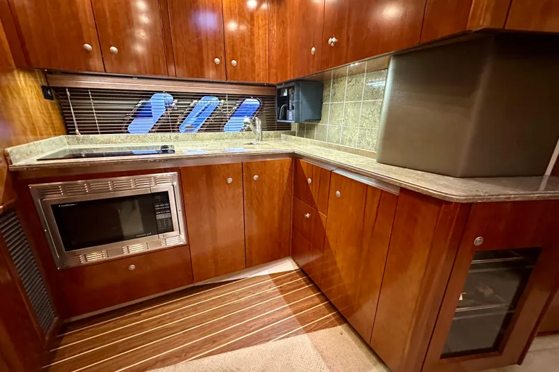 Slide: The Image of Luxurious 2009 Cruisers Yachts 460 Express kitchen with wood cabinetry and modern appliances. - 17
