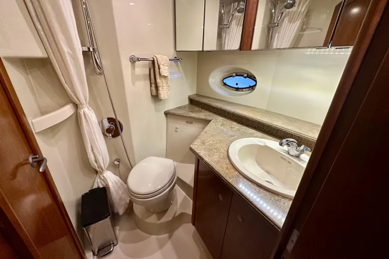 Slide: The Image of Luxurious bathroom in 2009 Cruisers Yachts 460 Express with elegant fixtures and porthole window. - 20
