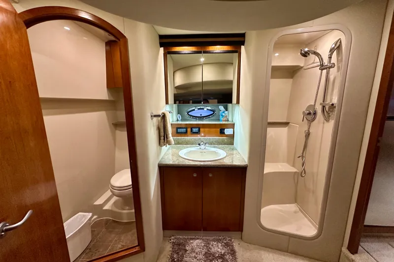 Slide: The Image of Luxurious bathroom in 2009 Cruisers Yachts 460 Express, featuring shower, sink, and toilet. - 24