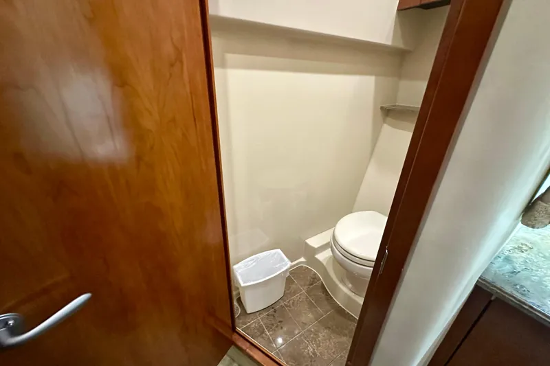 Slide: The Image of 2009 Cruisers Yachts 460 Express bathroom with wooden door and modern fixtures. - 25
