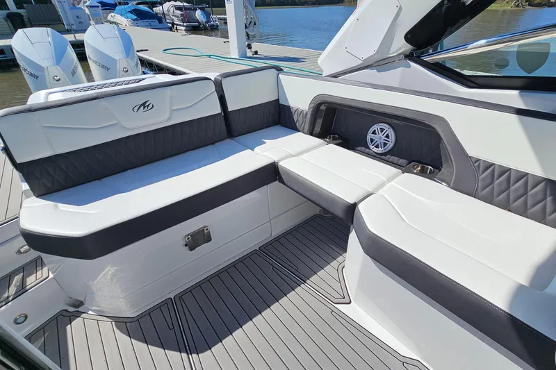Slide: The Image of 2019 Monterey 305SS Super Sport boat interior with cushioned seating and speaker system. - 11