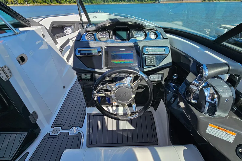 Slide: The Image of 2019 Monterey 305SS Super Sport boat cockpit with modern controls and steering wheel. - 18