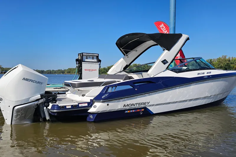 Slide: The Image of 2019 Monterey 305SS Super Sport boat with Mercury engine docked on a sunny day. - 2