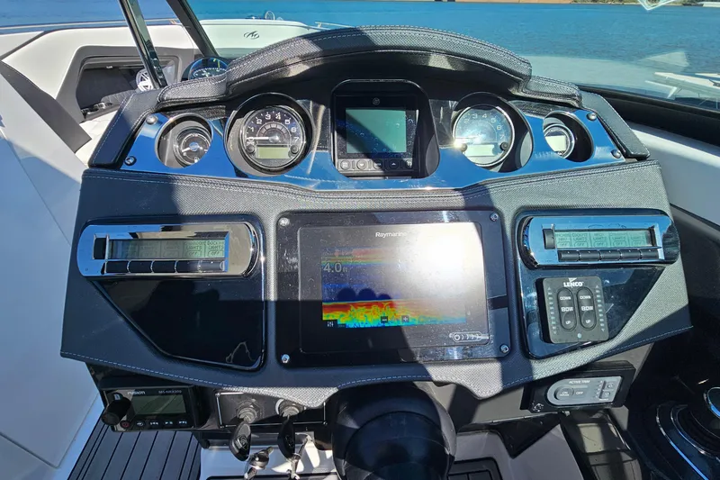 Slide: The Image of Dashboard of a 2019 Monterey 305SS Super Sport boat with navigation and control systems. - 20