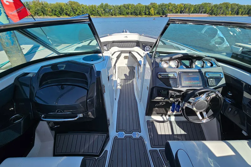 Slide: The Image of 2019 Monterey 305SS Super Sport boat interior with sleek dashboard and open water view. - 21