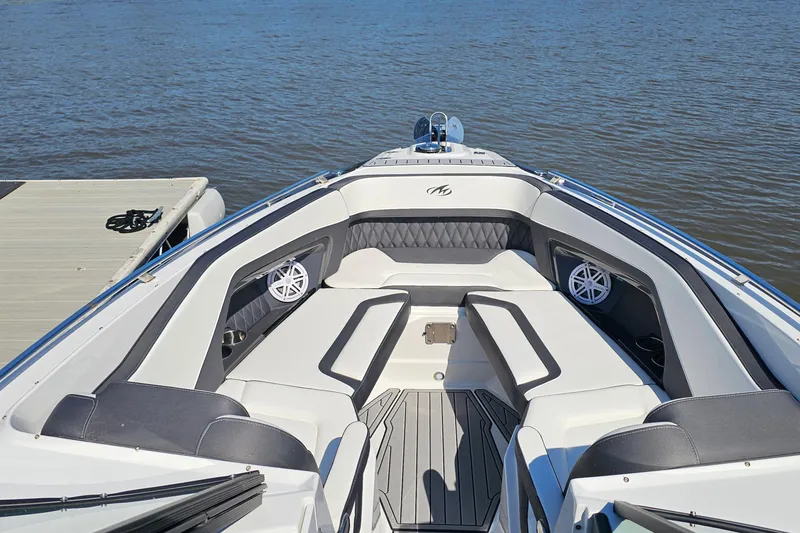 Slide: The Image of 2019 Monterey 305SS Super Sport boat interior with luxurious seating on calm water. - 23