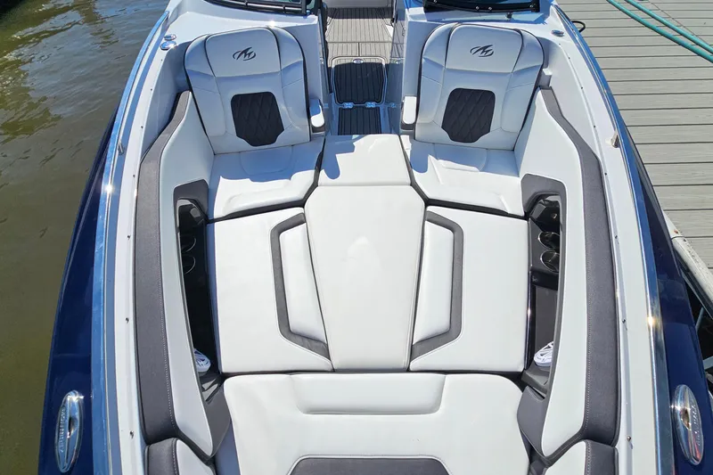 Slide: The Image of 2019 Monterey 305SS Super Sport boat interior with white and black seating, docked by water. - 28