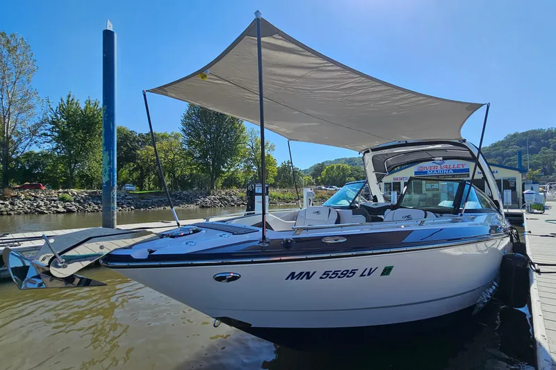 Slide: The Image of 2019 Monterey 305SS Super Sport boat docked at marina with canopy. - 31