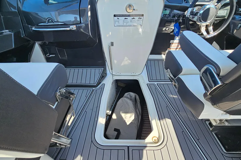 Slide: The Image of 2019 Monterey 305SS Super Sport interior with open storage compartment and sleek seating. - 34