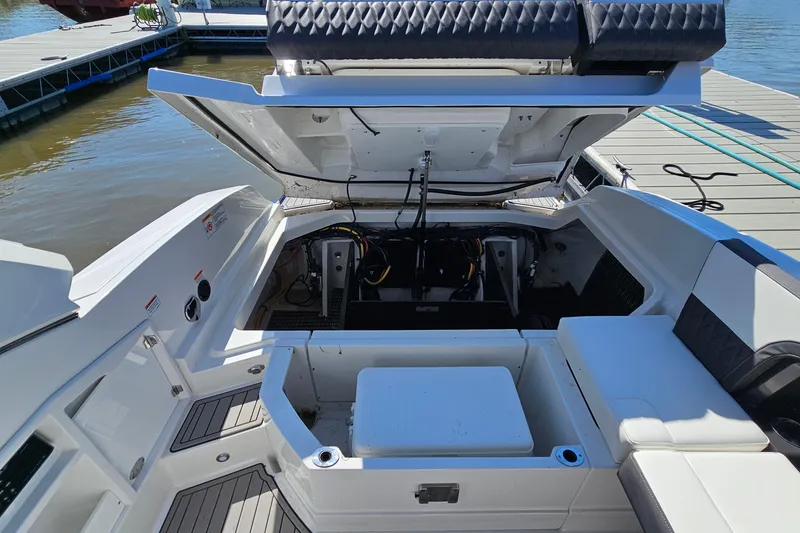 Slide: The Image of 2019 Monterey 305SS Super Sport boat with open engine compartment at dock. - 35