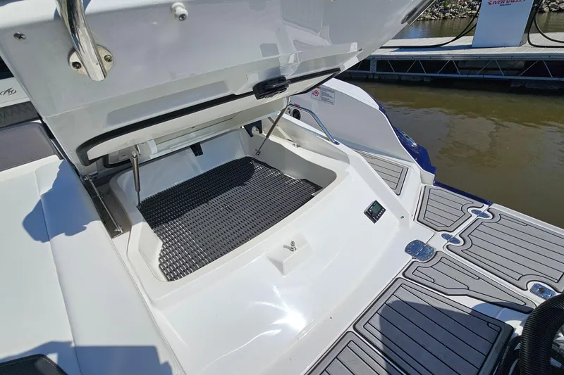 Slide: The Image of 2019 Monterey 305SS Super Sport boat with open storage compartment and sleek deck design. - 37
