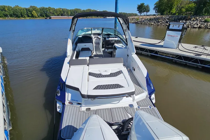 Slide: The Image of 2019 Monterey 305SS Super Sport boat docked on a calm river. - 6