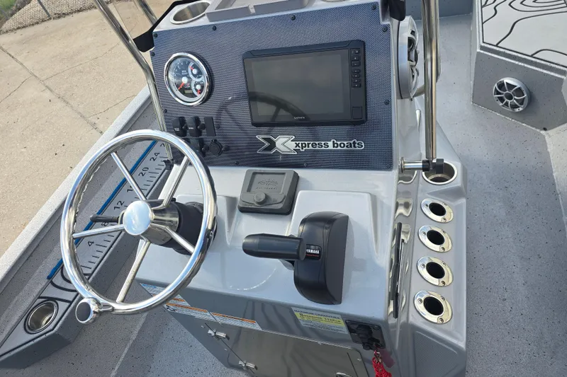 Slide: The Image of 2024 Xpress H22B Bay boat console with steering wheel and control panel. - 12